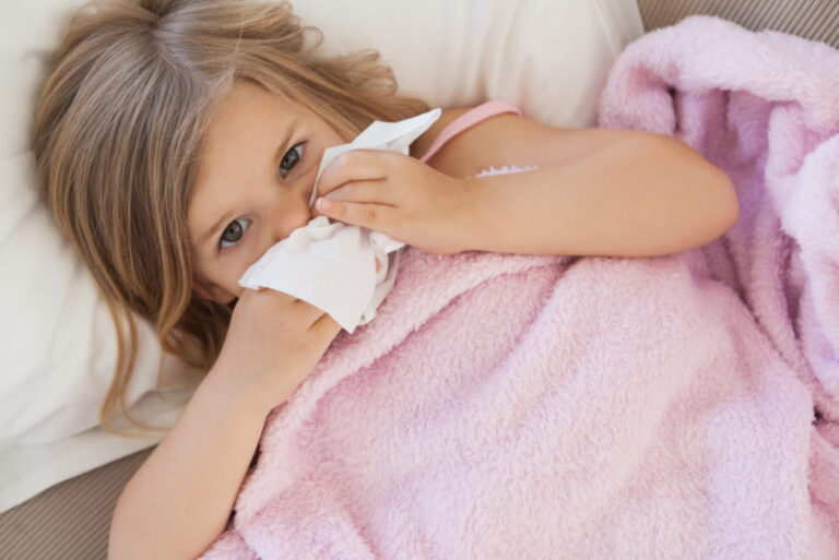 COMFORT sick little girl with colds covering her nose shutterstock 178435106 e1566493792316