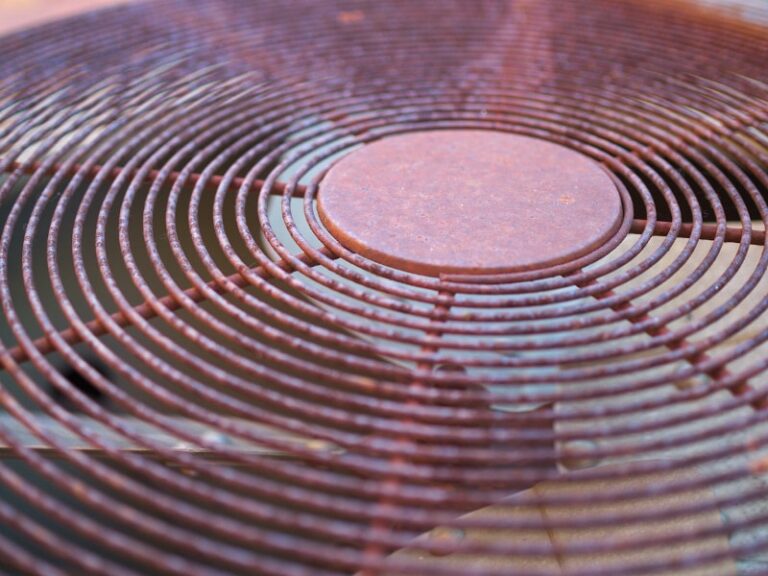 rusted grate of old outdoor AC unit