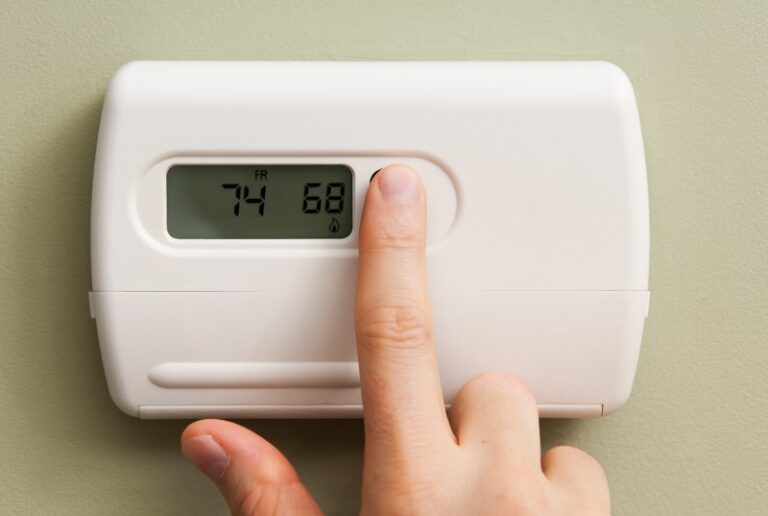 pushing button on thermostat min